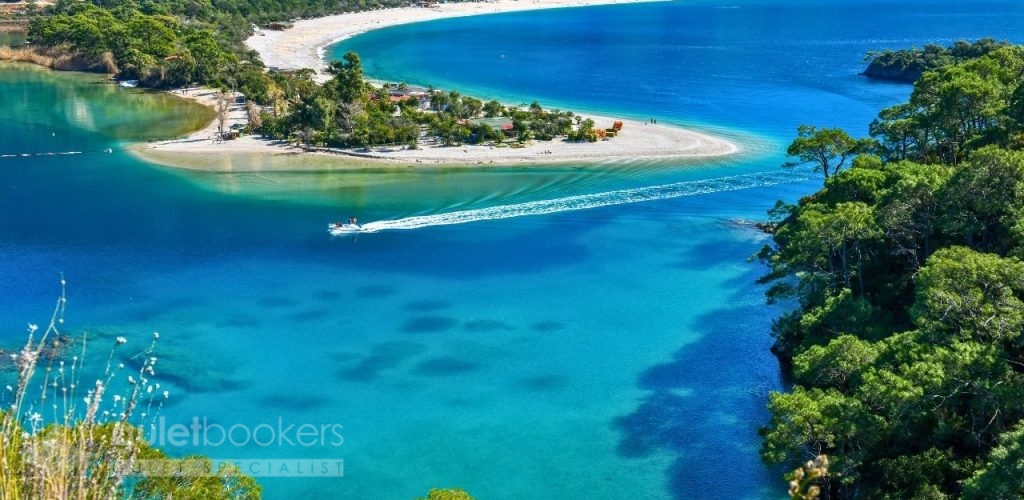 This protected bay offers mirror-like turquoise waters perfect for families of all ages.